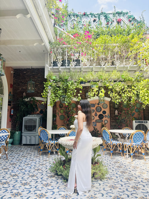 Taara ivory strapless column maxi dress, side view showing the front slit